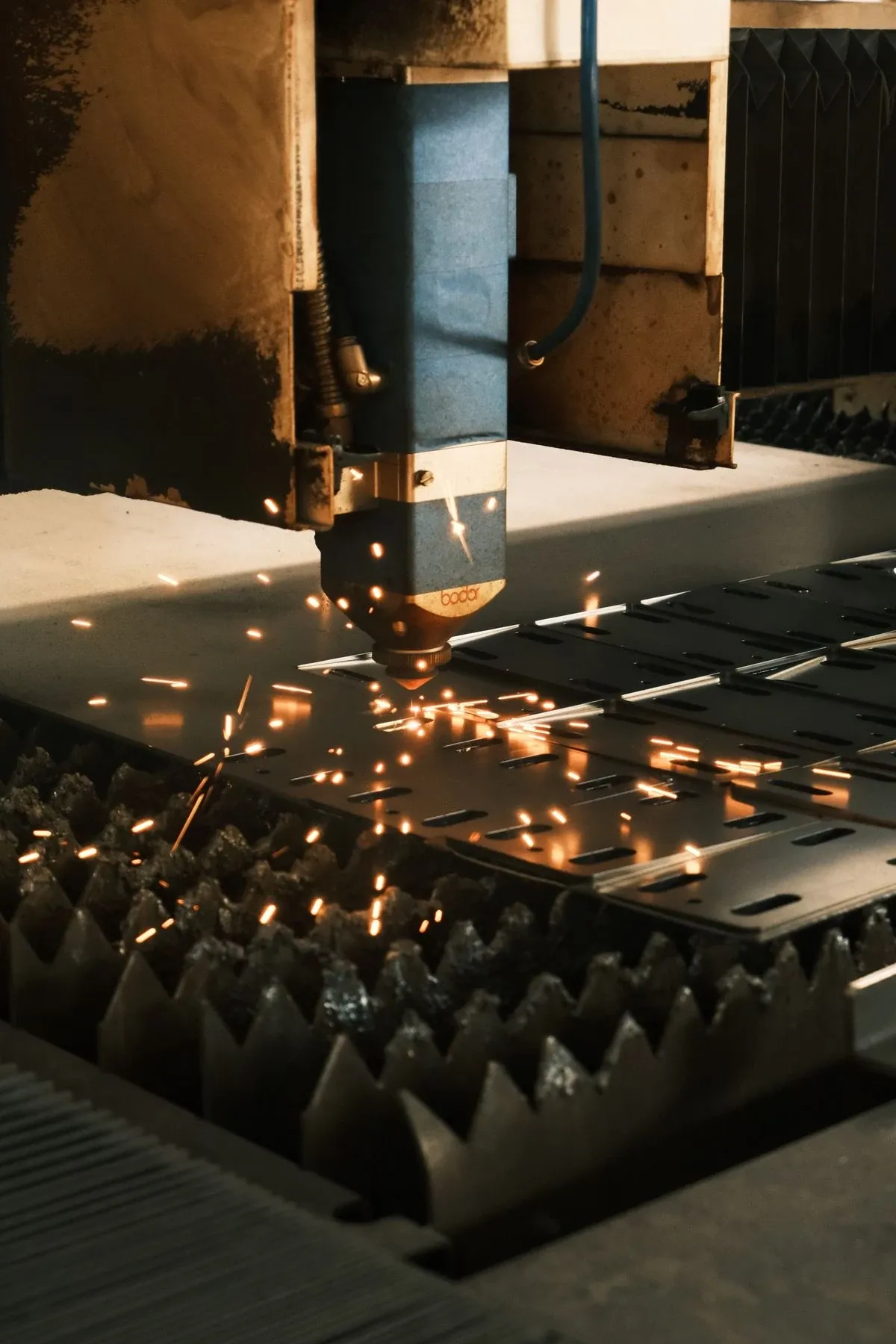 Laser cutting head working on a steel sheet